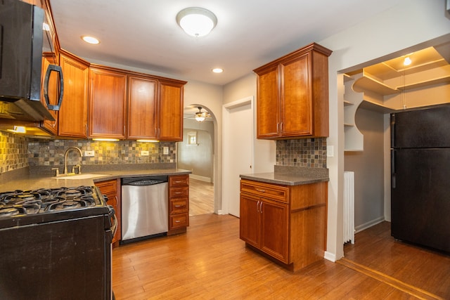 1103 Circle Ave, Forest Park, IL 60130 - kitchen with black appliances, light wood-style floors, decorative backsplash, a ceiling fan, and brown cabinetry