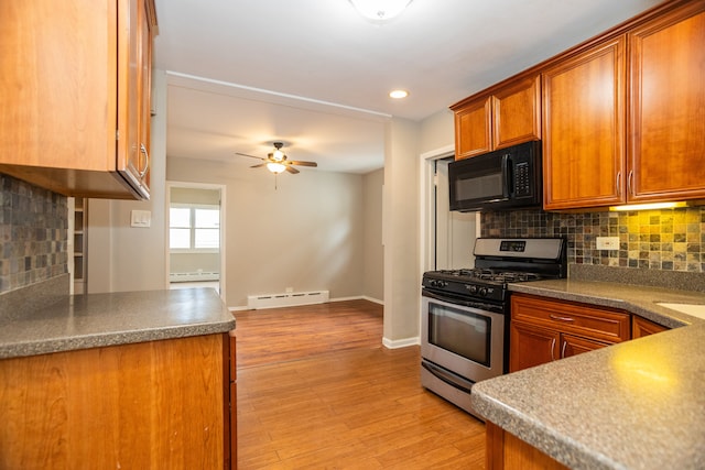 1103 Circle Ave, Forest Park, IL 60130 - kitchen with stainless steel range with gas stovetop, black microwave, baseboard heating, brown cabinetry, and ceiling fan