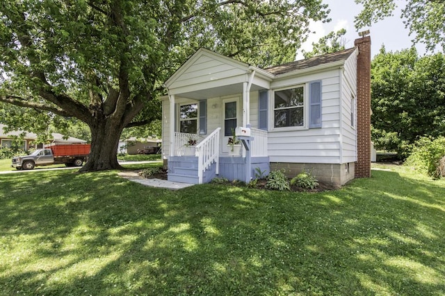 542 Whitney Ave, Winthrop Harbor, IL 60096 - view of front of home with a chimney and a front lawn