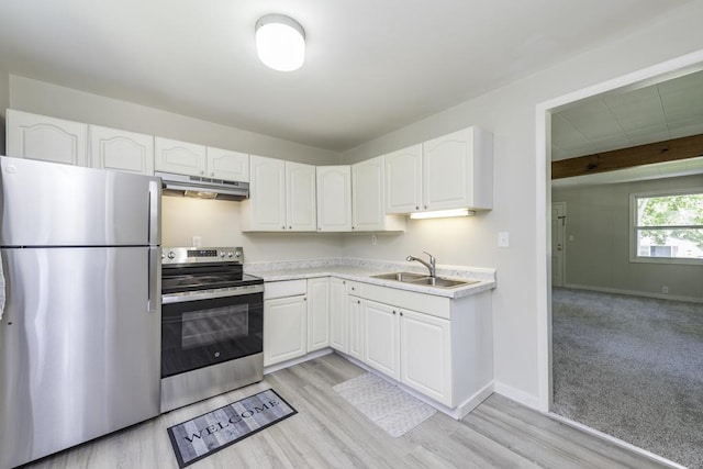 542 Whitney Ave, Winthrop Harbor, IL 60096 - kitchen featuring appliances with stainless steel finishes, under cabinet range hood, white cabinetry, light countertops, and light wood-style flooring