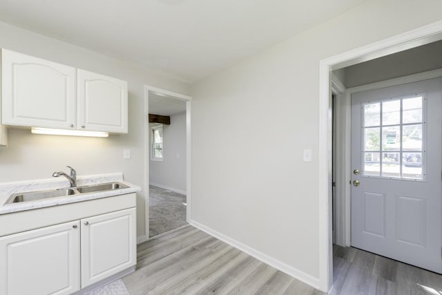542 Whitney Ave, Winthrop Harbor, IL 60096 - kitchen featuring white cabinetry, light wood-style flooring, and light stone countertops
