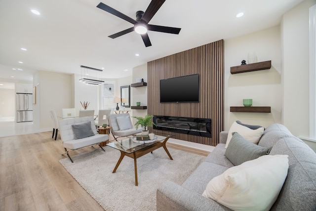 4143 N Drake Ave, Chicago, IL 60618 - living area with light wood-style flooring, a ceiling fan, recessed lighting, and a glass covered fireplace