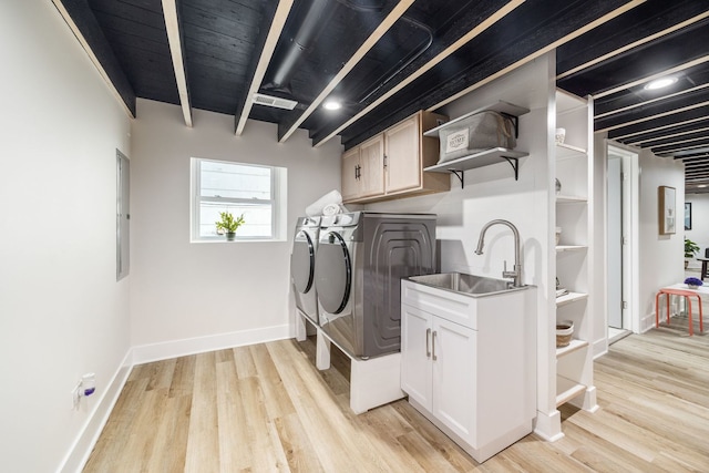 4143 N Drake Ave, Chicago, IL 60618 - washroom featuring separate washer and dryer, cabinet space, light wood-style flooring, and electric panel