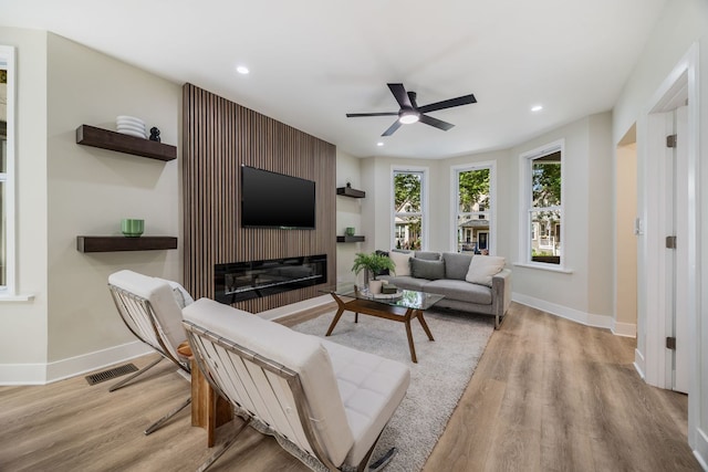 4143 N Drake Ave, Chicago, IL 60618 - living area with a glass covered fireplace, light wood-type flooring, a ceiling fan, and recessed lighting