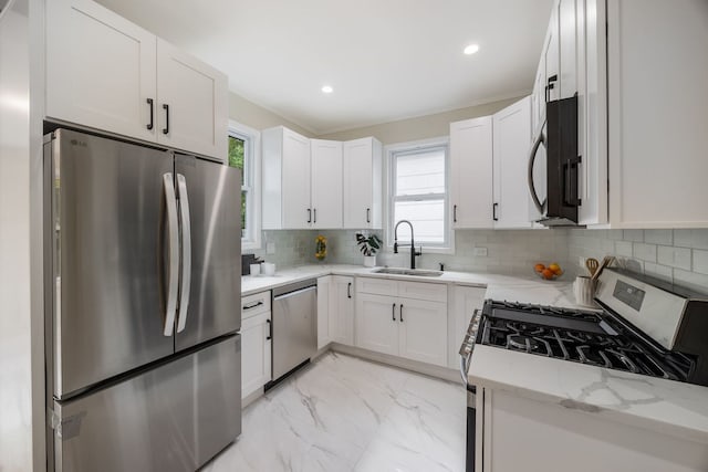 4143 N Drake Ave, Chicago, IL 60618 - kitchen featuring appliances with stainless steel finishes, light marble finish flooring, light stone countertops, white cabinetry, and tasteful backsplash