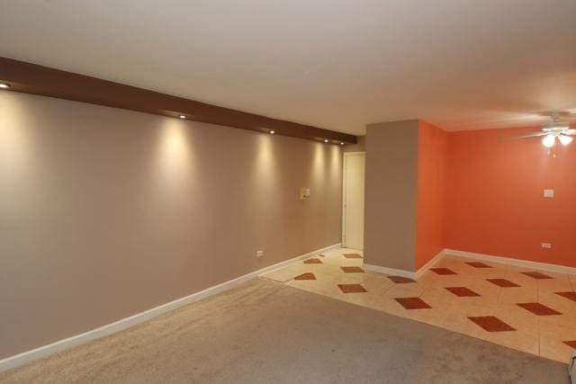 815 Grove Dr Unit 112, Buffalo Grove, IL 60089 - spare room featuring light carpet and a ceiling fan