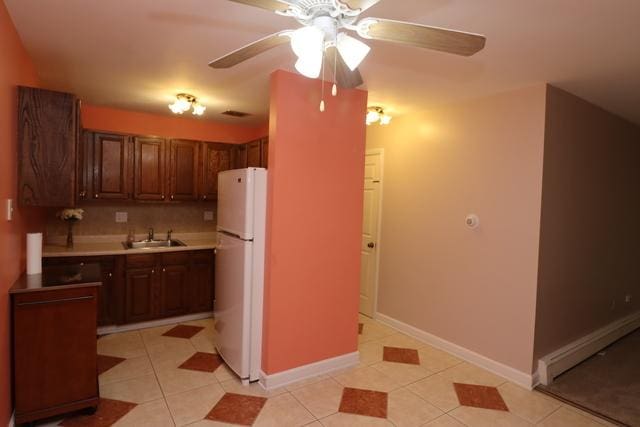 815 Grove Dr Unit 112, Buffalo Grove, IL 60089 - kitchen featuring freestanding refrigerator, ceiling fan, light countertops, and light tile patterned floors