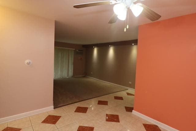 815 Grove Dr Unit 112, Buffalo Grove, IL 60089 - spare room featuring light tile patterned flooring and ceiling fan