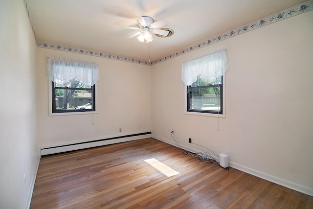731 Bishop Ct, Bradley, IL 60915 - empty room with a baseboard heating unit, healthy amount of natural light, wood finished floors, and a ceiling fan