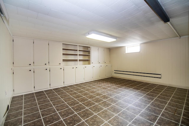 731 Bishop Ct, Bradley, IL 60915 - below grade area with baseboard heating and dark tile patterned flooring