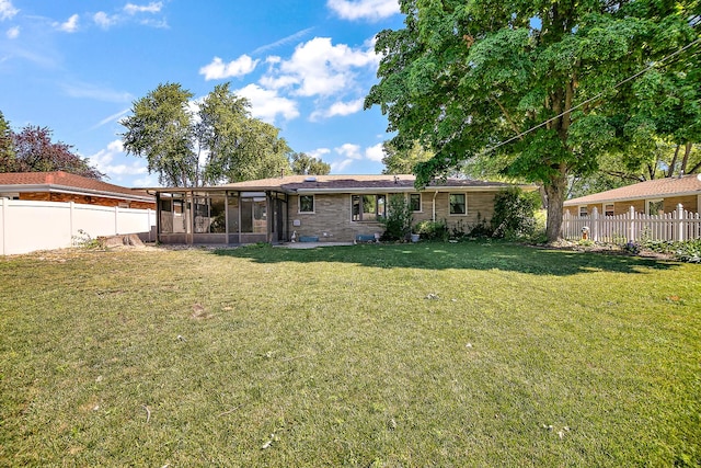 731 Bishop Ct, Bradley, IL 60915 - rear view of house featuring a sunroom and a fenced backyard