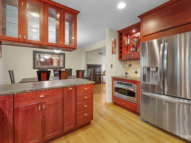 780 Chisholm Trl, Roselle, IL 60172 - kitchen with stainless steel appliances, light wood-style floors, backsplash, glass insert cabinets, and recessed lighting