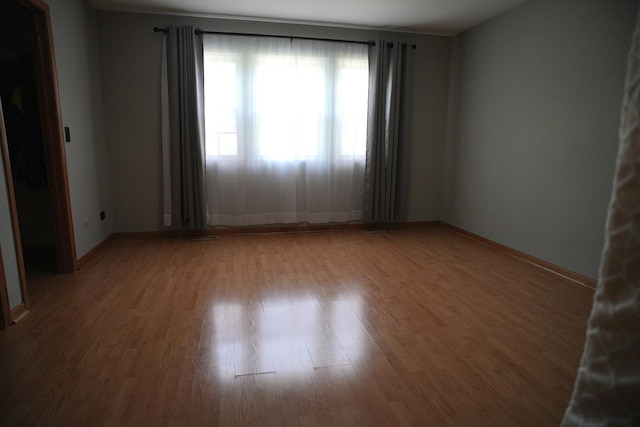 182 Cherrywood Ct, Romeoville, IL 60446 - spare room featuring wood finished floors and baseboards