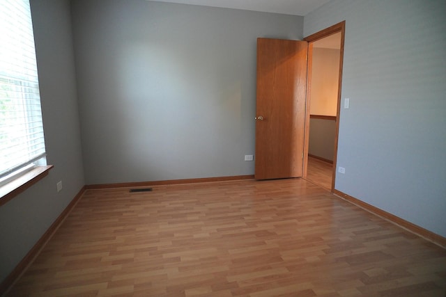 182 Cherrywood Ct, Romeoville, IL 60446 - spare room featuring light wood finished floors and baseboards