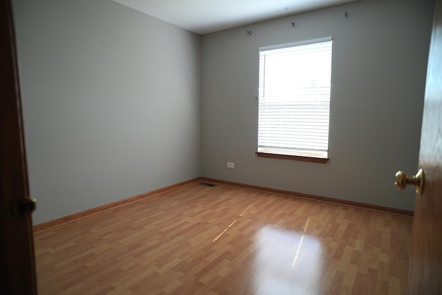 182 Cherrywood Ct, Romeoville, IL 60446 - empty room featuring light wood-style flooring and baseboards