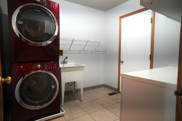 182 Cherrywood Ct, Romeoville, IL 60446 - laundry room featuring stacked washer / dryer and light tile patterned flooring