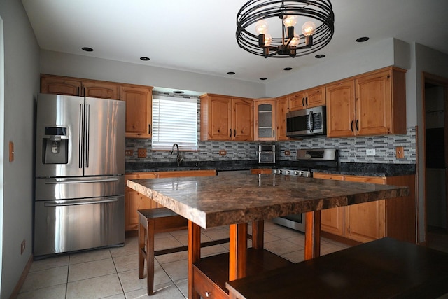 182 Cherrywood Ct, Romeoville, IL 60446 - kitchen with stainless steel appliances, a chandelier, backsplash, and light tile patterned floors