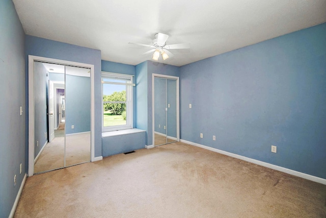 1642 Waterberry Ct, Bourbonnais, IL 60914 - unfurnished bedroom featuring two closets, carpet flooring, and a ceiling fan