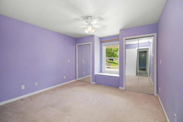 1642 Waterberry Ct, Bourbonnais, IL 60914 - unfurnished bedroom with multiple closets, light colored carpet, and a ceiling fan