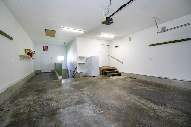 1642 Waterberry Ct, Bourbonnais, IL 60914 - garage featuring freestanding refrigerator and a garage door opener