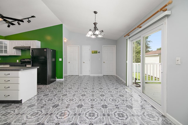 1642 Waterberry Ct, Bourbonnais, IL 60914 - kitchen with black appliances, under cabinet range hood, vaulted ceiling, dark countertops, and a chandelier