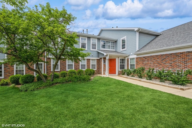 260 W Lynn Dr Unit 7-5B, Palatine, IL 60067 - view of front facade featuring brick siding, a front lawn, and a shingled roof