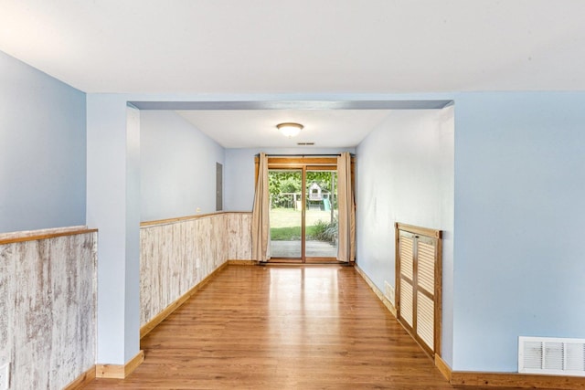 1020 Cassie Dr, Joliet, IL 60435 - unfurnished room featuring wood finished floors, a wainscoted wall, and wood walls