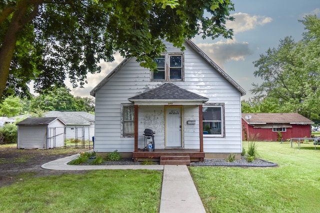 222 W S St, Dwight, IL 60420 - view of front of house featuring a storage shed, a front yard, and roof with shingles