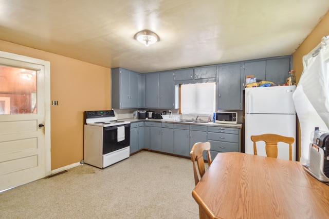 222 W S St, Dwight, IL 60420 - kitchen featuring white appliances, gray cabinetry, light countertops, and light carpet