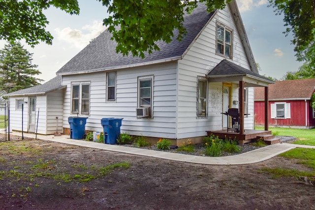 222 W S St, Dwight, IL 60420 - view of front facade featuring a shingled roof, cooling unit, and an outdoor structure