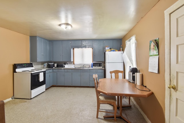 222 W S St, Dwight, IL 60420 - kitchen featuring white appliances, blue cabinetry, light colored carpet, and gray cabinetry