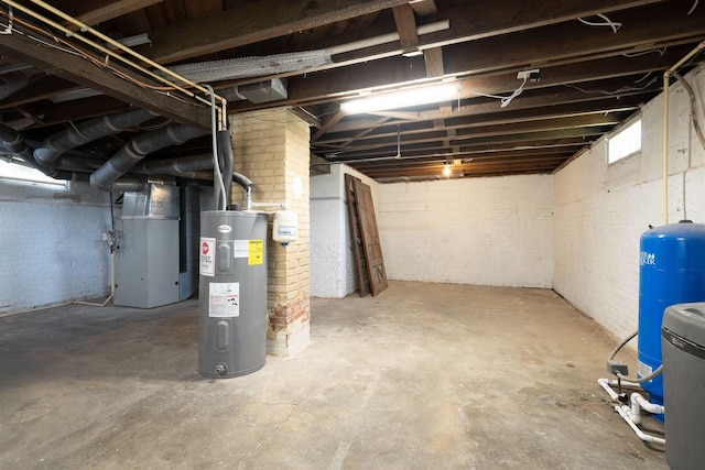 15313 Furrow Rd, Pekin, IL 61554 - below grade area featuring electric water heater, brick wall, a water pressure tank, and heating unit
