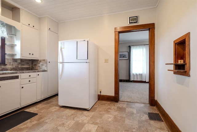 15313 Furrow Rd, Pekin, IL 61554 - kitchen with freestanding refrigerator, open shelves, white cabinetry, dark countertops, and ornamental molding
