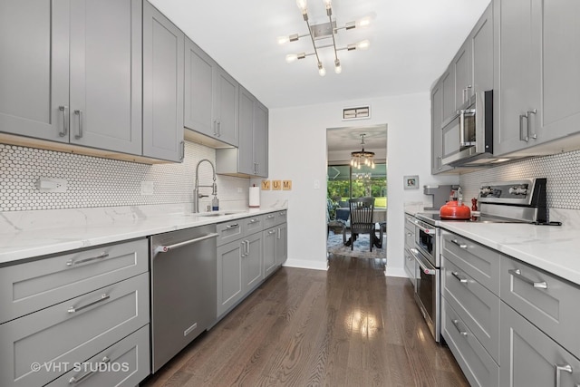 436 Shoreline Rd, Lake Barrington, IL 60010 - kitchen with appliances with stainless steel finishes, gray cabinets, dark wood-type flooring, and a chandelier