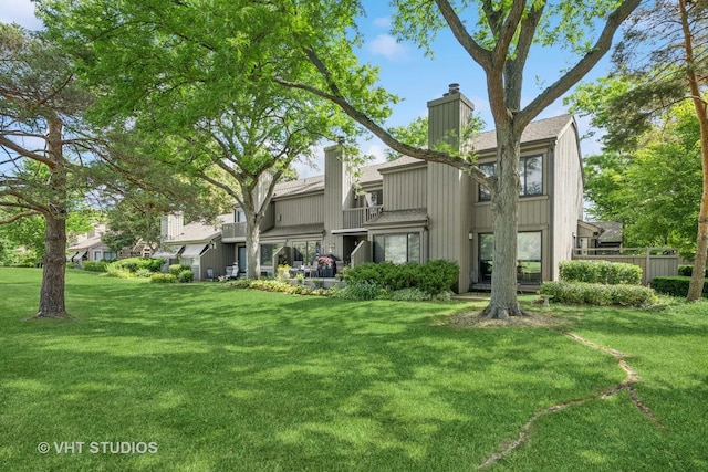 436 Shoreline Rd, Lake Barrington, IL 60010 - rear view of house featuring a chimney and a lawn