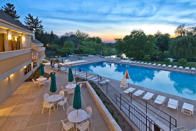 436 Shoreline Rd, Lake Barrington, IL 60010 - pool at dusk with a community pool and a patio area