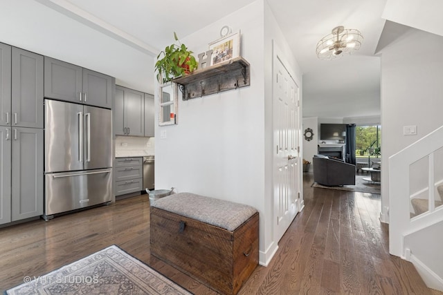 436 Shoreline Rd, Lake Barrington, IL 60010 - hallway with dark wood finished floors and a chandelier