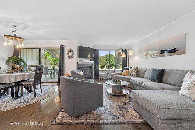 436 Shoreline Rd, Lake Barrington, IL 60010 - living area with wood finished floors, ornamental molding, a glass covered fireplace, and a chandelier