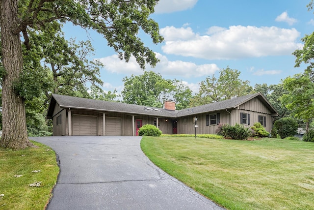 205 Sherwood Rd, Elgin, IL 60120 - single story home featuring a chimney, driveway, a garage, and a front lawn