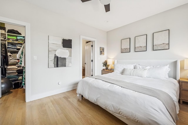 1423 W Huron St Unit 1, Chicago, IL 60642 - bedroom with a spacious closet, light wood-style floors, and a ceiling fan