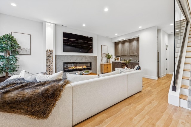 1423 W Huron St Unit 1, Chicago, IL 60642 - living room with a premium fireplace, light wood-style floors, recessed lighting, and stairs