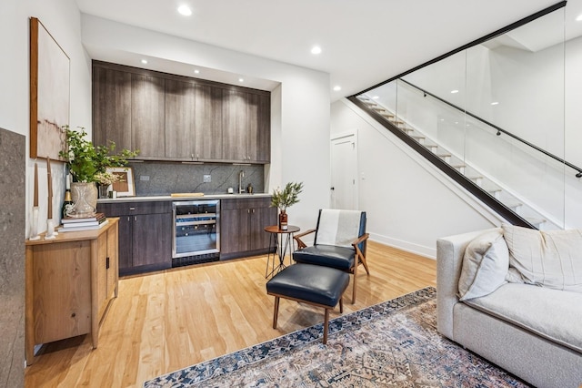 1423 W Huron St Unit 1, Chicago, IL 60642 - indoor bar with light wood-type flooring, stairs, beverage cooler, decorative backsplash, and recessed lighting