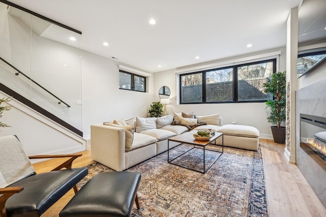 1423 W Huron St Unit 1, Chicago, IL 60642 - living area featuring light wood-style flooring, a tile fireplace, and recessed lighting
