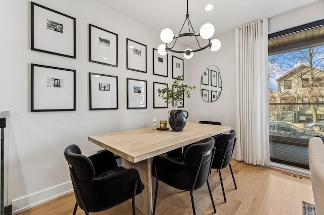 1423 W Huron St Unit 1, Chicago, IL 60642 - dining room with light wood-type flooring and a chandelier