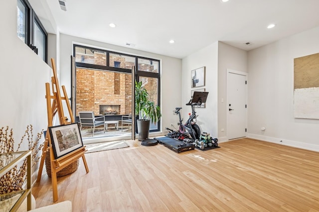 1423 W Huron St Unit 1, Chicago, IL 60642 - exercise area featuring wood finished floors, recessed lighting, and a fireplace