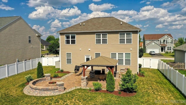 2267 Lundquist Dr, Aurora, IL 60503 - rear view of house with a gazebo, an outdoor fire pit, a patio, and a fenced backyard