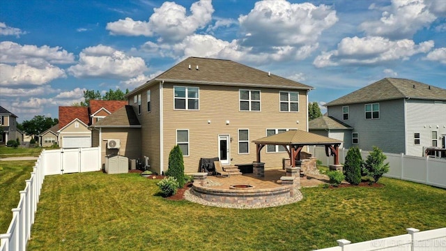 2267 Lundquist Dr, Aurora, IL 60503 - rear view of house with a gazebo, a fenced backyard, a patio area, and a storage unit