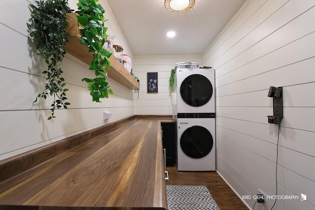 1115 E Fox Chase Dr, Round Lake Beach, IL 60073 - washroom with stacked washer and clothes dryer, wood walls, and dark wood-style flooring