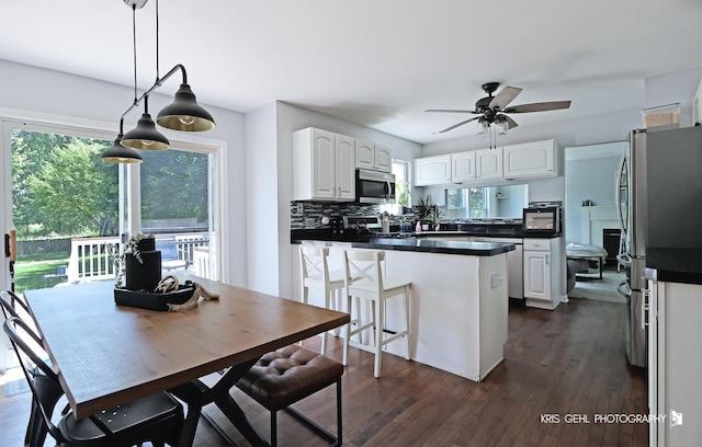 1115 E Fox Chase Dr, Round Lake Beach, IL 60073 - kitchen featuring appliances with stainless steel finishes, dark countertops, white cabinetry, and healthy amount of natural light