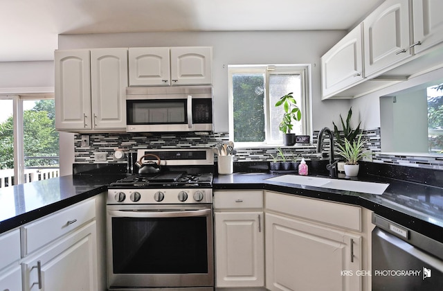 1115 E Fox Chase Dr, Round Lake Beach, IL 60073 - kitchen with appliances with stainless steel finishes, backsplash, white cabinetry, and dark countertops
